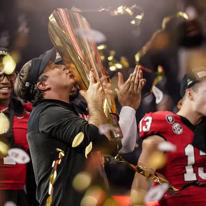 Georgia head coach kisses championship trophy